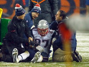 New England Patriots tight end Rob Gronkowski (87) is attended to after getting injured against the Denver Broncos in Denver. (AP Photo/Jack Dempsey)