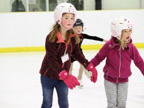 A pair of young skaters circle the ice at the Vermilion Stadium on Thursday, Dec. 3. The Vermilion Skating Club raised $1,415 for the Stollery Children's Hospital with its first Stollery Skate-a-thon.