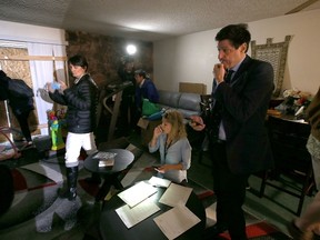 Reporters look through the living room inside the home of shooting suspect Syed Farook on December 4, 2015 in Redlands, California. Dozens of members of the media were let into the home of shooting suspect Syed Farook by the property owner. The San Bernardino community is mourning as police continue to investigate a mass shooting at the Inland Regional Center in San Bernardino that left at least 14 people dead and another 21 injured.  Justin Sullivan/Getty Images/AFP