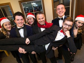 Crooners Zach Peddie, second from left, Rick Kish, and Connor Boa hold up Eric Charbonneau joined by Laura Martineau, left, Elena Reyes and Kaitlin Benoit at a rehearsal for their Retro Crooner Christmas, running next week, Thursday to Saturday, at the Grand Theatre?s McManus Studio. (CRAIG GLOVER, The London Free Press)