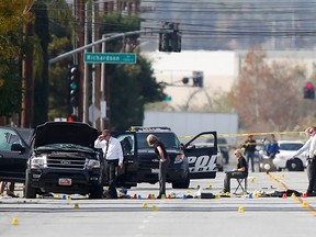 Police and Sheriff's Office Crime Scene Iinvestigators examine evidence at the scene of the investigation around an SUV where two suspects were shot by police following a mass shooting in San Bernardino, California December 3, 2015.  Authorities on Thursday were working to determine why Syed Rizwan Farook 28, and Tashfeen Malik, 27, opened fire at a holiday party of his co-workers in Southern California, killing 14 people and wounding 17 in an attack that appeared to have been planned. REUTERS/Mike Blake