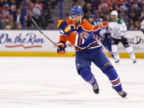 Edmonton defenceman Darnell Nurse (25) chases a loose puck during the second period of a NHL game between the Edmonton Oilers and the Dallas Stars at Rexall Place in Edmonton, Alta. on Friday December 4, 2015. Ian Kucerak/Edmonton Sun/Postmedia Network