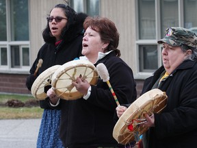 Lisa Osawamick, left, Sue Manning and Jeannine Aubry, of the N'Swakamok Drum Sisters, perform a number at a vigil at the YWCA in Sudbury, Ont. on Friday December 4, 2015. The event was held to mark 26 years since the Dec. 6, 1989 massacre at Montreal's Ecole Polytechnique, which claimed the lives of 14 women, and to remember all women who have been murdered or gone missing.  John Lappa/Sudbury Star/Postmedia Network