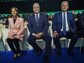 French French Environment Minister Segolene Royal, left, Premier of Quebec Canadian Phillippe Cuillard, center, and Former US Vice President Al Goregestures listening during the"Action Day"at the COP21, United Nations Climate Change Conference, in Le Bourget north of Paris, Saturday, Dec. 5, 2015. (AP PhotoMichel Euler)