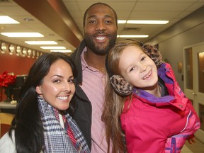 Edmonton Eskimos offensive lineman Chris Greaves (c) walks through the air terminal with his fiancee Elizabeth Aquin (l) and her daughter Isabelle upon his arrival in Winnipeg, Man. Tuesday November 24, 2015 for the Grey Cup.
Brian Donogh/Winnipeg Sun/Postmedia Network