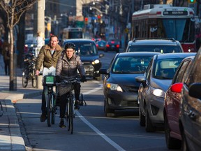 Cyclists make their way along College St. towards Spadina Ave. in Toronto, Ont. on Wednesday December 2, 2015. Ernest Doroszuk/Toronto Sun