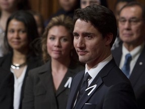 Prime Minister Justin Trudeau waits for the start of the Speech from the Throne as his wife Sophie looks on in the Senate chamber on Parliament Hill in Ottawa, Canada December 4, 2015. REUTERS/Fred Chartrand/Pool