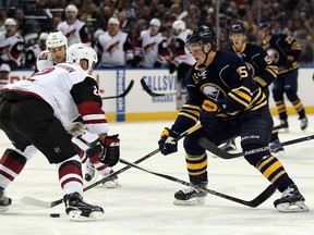 Dec 4, 2015; Buffalo, NY, USA; Buffalo Sabres center Jack Eichel (15) skates with the puck past Arizona Coyotes defenseman Nicklas Grossmann (2) during the second period at First Niagara Center. Mandatory Credit: Timothy T. Ludwig-USA TODAY Sports