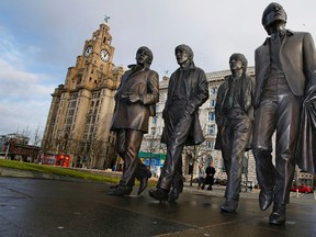A new statue of the Beatles which was unveiled by John Lennon's sister Julia Baird, not pictured, outside the iconic Liver Building, in Liverpool northwest England  Friday Dec. 4, 2015. (Peter Byrne/PA via AP)