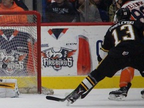 Sarnia Sting goalie Kaden Fulcher makes a save while teammate Sasha Chmelevski keeps Flint Firebirds winger Zach Grzelewski in check during the Ontario Hockey League game at the Dort Federal Event Center on Saturday Dec. 5, 2015 in Flint, Mich. Fulcher, a 17-year-old Brigden native, made his OHL debut. Terry Bridge/Sarnia Observer/Postmedia Network