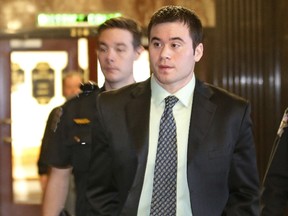 Daniel Holtzclaw is led from a courtroom during a break in testimony in Oklahoma City, Wednesday, Dec. 2, 2015. Holtzclaw, a former Oklahoma City police officer, is facing dozens of charges alleging he sexually assaulted 13 women while on duty. (AP Photo/Sue Ogrocki)