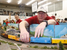 Don Duthie, of the Ganaraska Railway Modellers fix a derailed model train during day one of the two day showcase at Quinte Secondary School