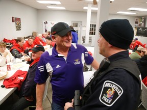 Red Nose Chair Rick Watt speaks to Const. Aaron Bucci Saturday night at the Catharine street dispatch centre.