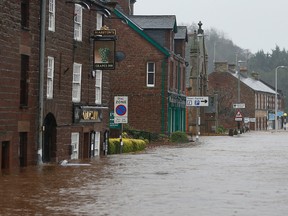 Flooded roads in the centre of Appleby, north west England, as Storm Desmond hits the United Kingdom, Saturday Dec. 5, 2015. Roads have been closed throughout the North and Scotland as Storm Desmond caused road chaos, landslides and flooding. (Owen Humphreys/PA via AP)