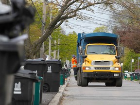 City of Toronto workers pick up garbage. (MICHAEL PEAKE/TORONTO SUN files)