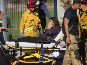 A victim is wheeled away on a stretcher following a mass shooting at a social services facility, Wednesday, Dec. 2, 2015, in San Bernardino, Calif. (David Bauman/The Press-Enterprise via AP)