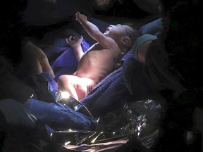 A newborn baby boy who was left in a manger at the Holy Child Jesus Church in the Queens borough of New York City is pictured in this undated handout photo provided by Father Christopher Ryan Heanue. The mother who left her newborn son in the manger at the New York City church will not face criminal charges for giving him up, a prosecutor said on Nov. 25. A custodian on Nov. 23 found the crying infant with his umbilical cord still attached wrapped in towels and placed in the indoor nativity scene at the Holy Child Jesus Church in Queens, New York police said.  REUTERS/Father Christopher Ryan Heanue/Handout via Reuters