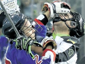 Glen Bryan (left) of the Toronto Rock tangles with Kyle Rubisch of the Saskatchewan Rush during NLL play at TD Place. Scott Grant/photo