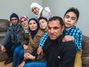 Recently arrived Syrian refugee family in their temporary home in Vaughan. Father and mother are - Rakan and Houda. Kids (from left) are - Najeeb, 19, Eaman, 17, Nourhan, 13 (behind), Ebraheem, 9 and Talha, 10. (Ernest Doroszuk/Toronto Sun)