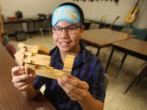 Grade 8 student Kohl Clarke displays the blindfold and wooden blocks that are part of an empathy game, used by students to reduce conflict. (Winnipeg Sun/Postmedia Network)