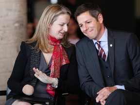 Lawyer Maria Mitousis, who was injured in an office bombing on July 3, speaks with Winnipeg Mayor Brian Bowman prior to a press conference in Winnipeg in September. Both the lawyer and mayor are nominees for Winnipeg Sun newsmaker of the year. (John Woods/THE CANADIAN PRESS)