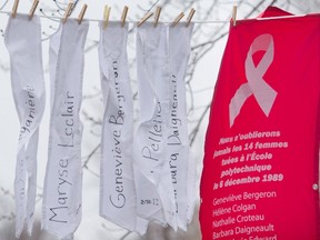 The names of some of the fourteen women murdered at Ecole Polytechnique on December 6, 1989, hang on a line during a ceremony to mark the 26th anniversary of the massacre, in Montreal, on Sunday, Dec. 6, 2015. THE CANADIAN PRESS/Graham Hughes