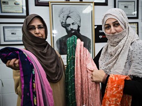 Samina Mian, left, and Nudrat Mansoor, right, show off colourful hijabs during the Je Suis Hijabi event at Baitul Hadi Mosque in Edmonton, Alta., on Sunday, Dec. 6, 2015. Community members were invited to try on a hijab. The event, which was organized by Ahmadiyya Muslim Jama`at Canada, is a national campaign aimed at removing misconceptions and highlighting the significance of the hijab. Codie McLachlan/Edmonton Sun/Postmedia Network