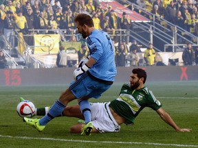Portland Timbers midfielder Diego Valeri, right, of Argentina, scores a goal against Columbus Crew goalkeeper Steve Clark during the first half of the MLS Cup championship soccer game Sunday, Dec. 6, 2015, in Columbus, Ohio. (AP/Paul Vernon)
