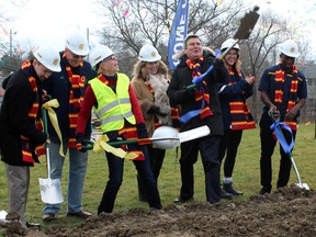 From left, Kingston Mayor Bryan Paterson, Paul and Vicki Hand, Kim and Stu Lang, and student-athletes Micah Vermeer and Curtis Carmichael take part in the ceremonial groundbreaking for the new Richardson Stadium on Saturday. (Steph Crosier/The Whig-Standard)