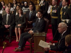 Canada's Prime Minister Justin Trudeau (seated, C) listens as Governor General David Johnston delivers the Speech from the Throne in the Senate chamber on Parliament Hill in Ottawa on December 4, 2015. REUTERS/Fred Chartrand/Pool