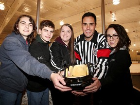 Gino Donato/Sudbury Star
Referee Eric Caetano, with volunteers Kieran and Bryce Davie, Meghan McInnes and Jurnee Parisotto-Charron ,  prepare to collect donations on Sunday. Caetano will be holding a fundraiser for NEO Kids for the next few weeks. Volunteer Brandon Maki is absent for the photo.