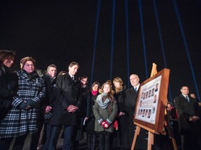 Beams of light, one for each victim, shine over Prime Minister Justin Trudeau as he takes part in a memorial ceremony for the fourteen women murdered at Ecole Polytechnique on December 6, 1989, twenty six years ago today, Sunday, Dec. 6, 2015. THE CANADIAN PRESS/Paul Chiasson