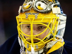 The Buffalo Sabres Linus Ullmark (35) wears what appears to be a Minions face mask during the pre game warm-up prior to a game against the Edmonton Oilers at Rexall Place, in Edmonton, Alta. on Sunday Dec. 6, 2015. David Bloom/Edmonton Sun/Postmedia Network