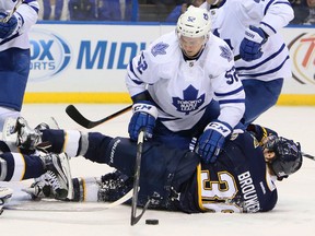 Players pile up in front of goaltender Garret Sparks during the Maple Leafs-St. Louis Blues game on Saturday night. Goal production is down to 2.65 goals per game this season. (The Associated Press)