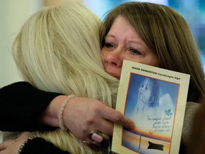 (left to right) Jillian Phillips and Calico Dawn Riley console each other during the MADD Edmonton Candlelight Vigil at Holy Trinity Anglican Church, 10037 - 84 Ave., in Edmonton, Alta. on Sunday Dec. 6, 2015.