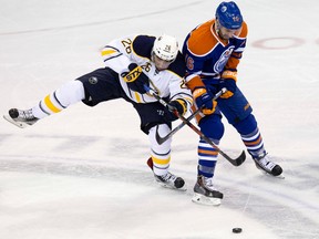 The Edmonton Oilers' Teddy Purcell (16) battles the Buffalo Sabres' Matt Moulson (26) during second period NHL action at Rexall Place, in Edmonton, Alta. on Sunday Dec. 6, 2015. David Bloom/Edmonton Sun/Postmedia Network