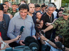 Then-Serbian Minister of Defence Bratislav Gasic, centre, speaks to the media in this Sept. 17, 2015 file photo. (Sandor Ujvari/MTI via AP)