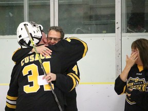 Goaltender John Cusack hugs Leslie Cusack, Chris' father, following the final Chris Cusack Memorial game at the Vermilion Stadium on Saturday night.