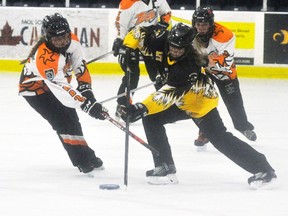 Kathryn Simmons (5) of the Mitchell U16A ringette team battles for the ring during recent action against Cambridge. ANDY BADER/MITCHELL ADVOCATE