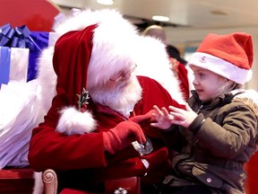 A Santa at the Cleveland Centre in Middlesbrough, U.K., asks a hearing-impaired girl what she wants for Christmas using sign language. (YouTube screenshot)
