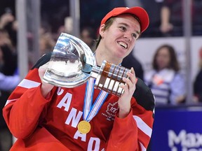 Canada’s Connor McDavid skates with the trophy following his team’s gold medal win over Russia at the World Junior Championship in Toronto on Jan. 5, 2015. (THE CANADIAN PRESS/Frank Gunn)