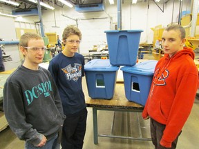From left, shop students Nicholas Portiss, Craig Machan and Del Prentice, are shown on Monday December 7, 2015 in Sarnia, Ont., with cat tote shelters being made by students at Alexander Mackenzie Secondary School for the organization Cat Chance. The shelters provide a warm, dry home for feral and stray cats. (Sarnia Observer/Postmedia Network)
