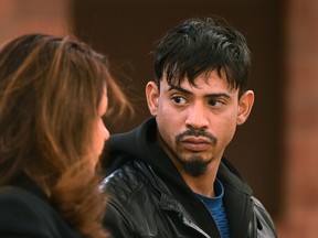 Amador Medina, right, of Hartford, listens to public defender Johanna Canning during his arraignment at Hartford Superior Court Monday, Dec. 7, 2015, in Hartford, Conn. (Cloe Poisson/Hartford Courant via AP. Pool)