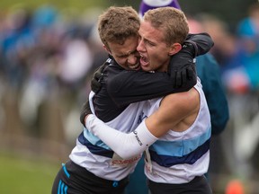 Kingston Collegiate runners Ben Workman, left, and Cam Linscott embrace after the senior boys race at the Ontario Federation of School Athletic Associations cross-country championships in 2014. Linscott won the race and Workman finished third.