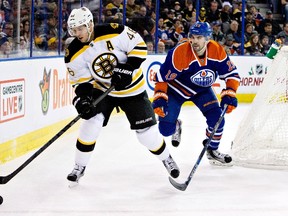 Justin Schultz chases Bruins forward Davvid Krejci behind the net during last Wednesday's 3-2 win over Boston at Rexall Place. (USA TODAY SPORTS)