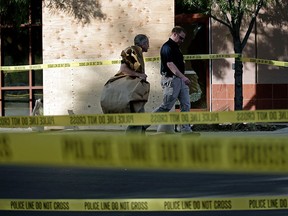 Investigators work the site of a mass shooting at the Inland Regional Center on Monday, Dec. 7, 2015, in San Bernardino, Calif. (AP Photo/Jae C. Hong)