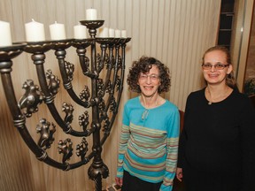 Jackie Mills, left, and Lisa Cassidy, seen here with the menorah in the Beth Israel Synagogue in Kingston on Monday are looking forward to seeing the community participate in the Kingston Jewish Council's annual Light Up the Night Hanukkah celebration on Wednesday. (Julia McKay/The Whig-Standard)
