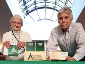 Mary Morgan and Bryan Sarabin man the donation table for the Christmas Bureau at Commerce Place in Edmonton, Alberta, on December 7, 2015.  There has been a increase in demands for hampers this year.