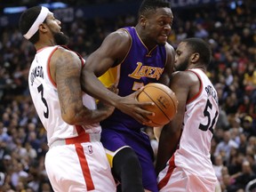 Raptors James Johnson and Patrick Patterson try to box out  Los Angeles Lakers Julius randle at the ACC on Monday. (Craig Robertson/Toronto Sun/Postmedia Network)