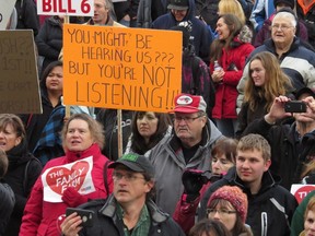 Farmer and farm families gather at the Alberta Legislature in Edmonton on Thursday, Dec. 3, 2015.(Dean Bennett/The Canadian Press)